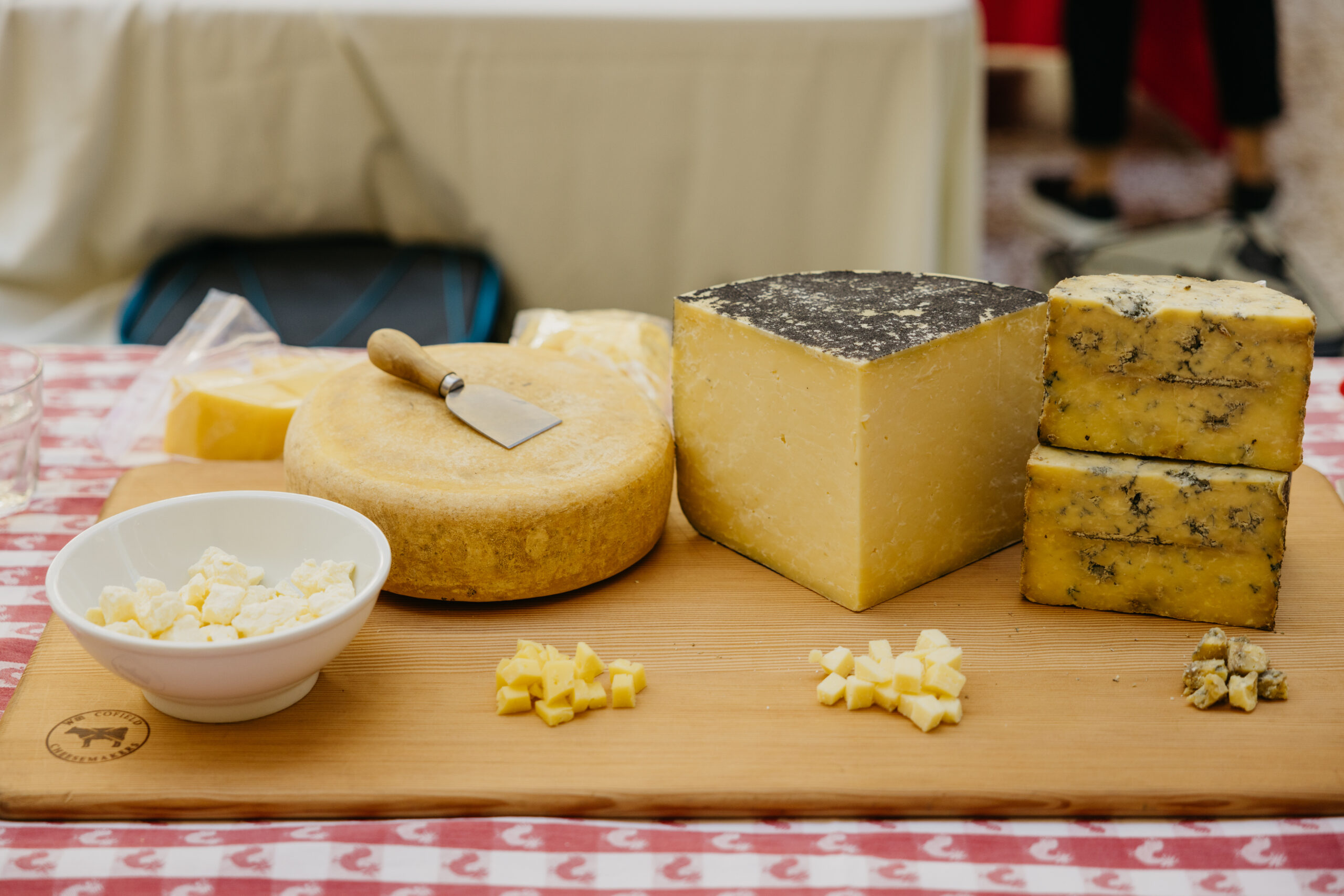 three cheeses displayed on a wood board