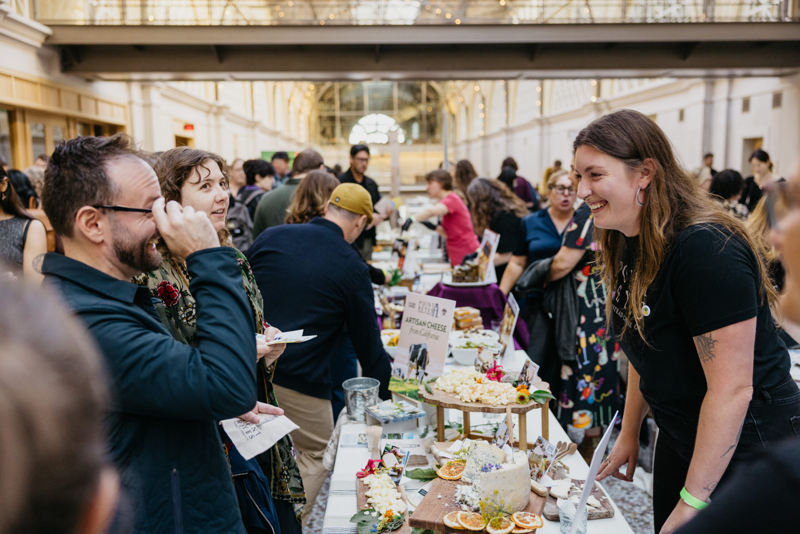vendor and guest laughing over table